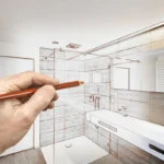 man drawing a bathroom design with pen