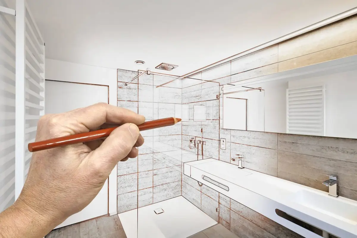 man drawing a bathroom design with pen