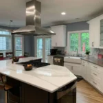 white kitchen with quartz countertops and island