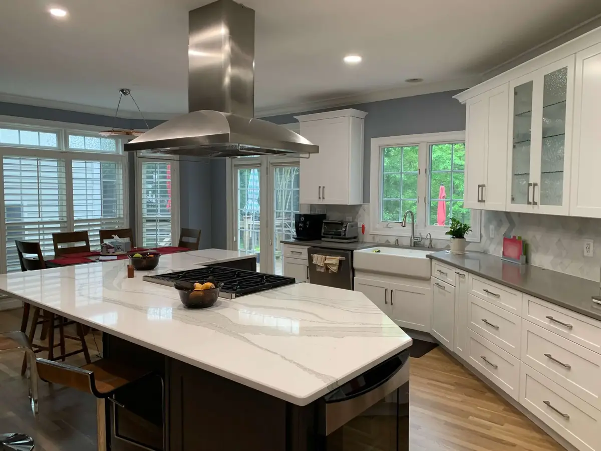 white kitchen with quartz countertops and island