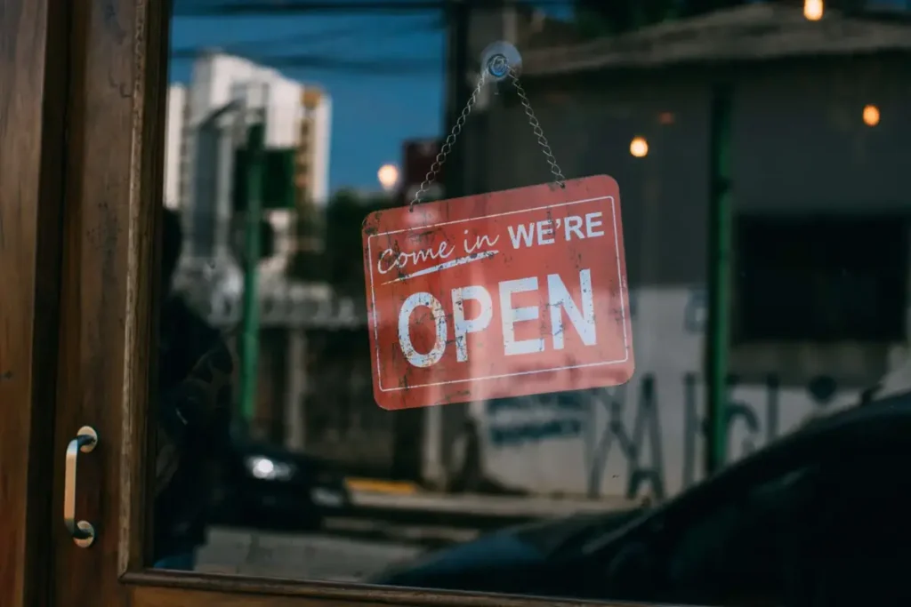 red open sign hangs on cabinet store door