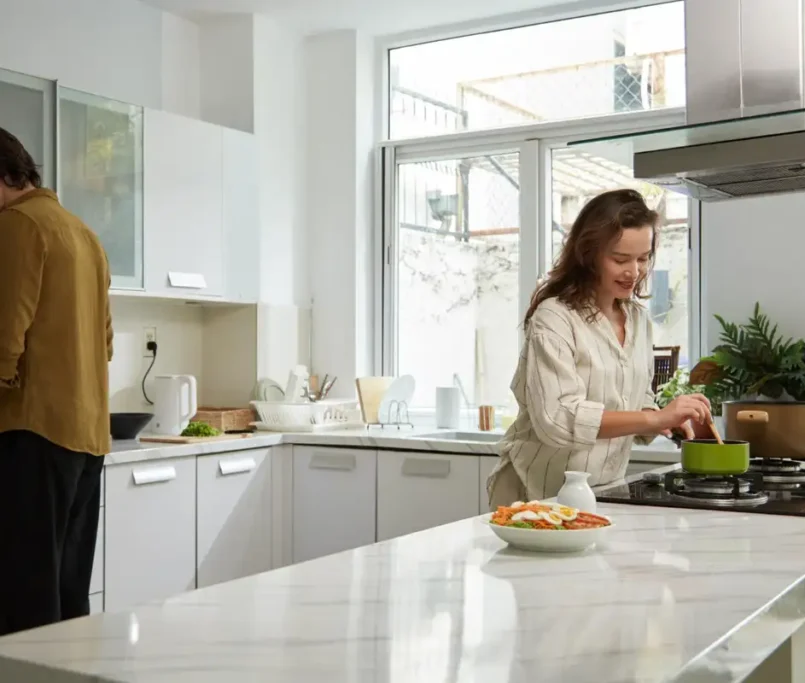 Couples prepares food on quarts vs granite countertops