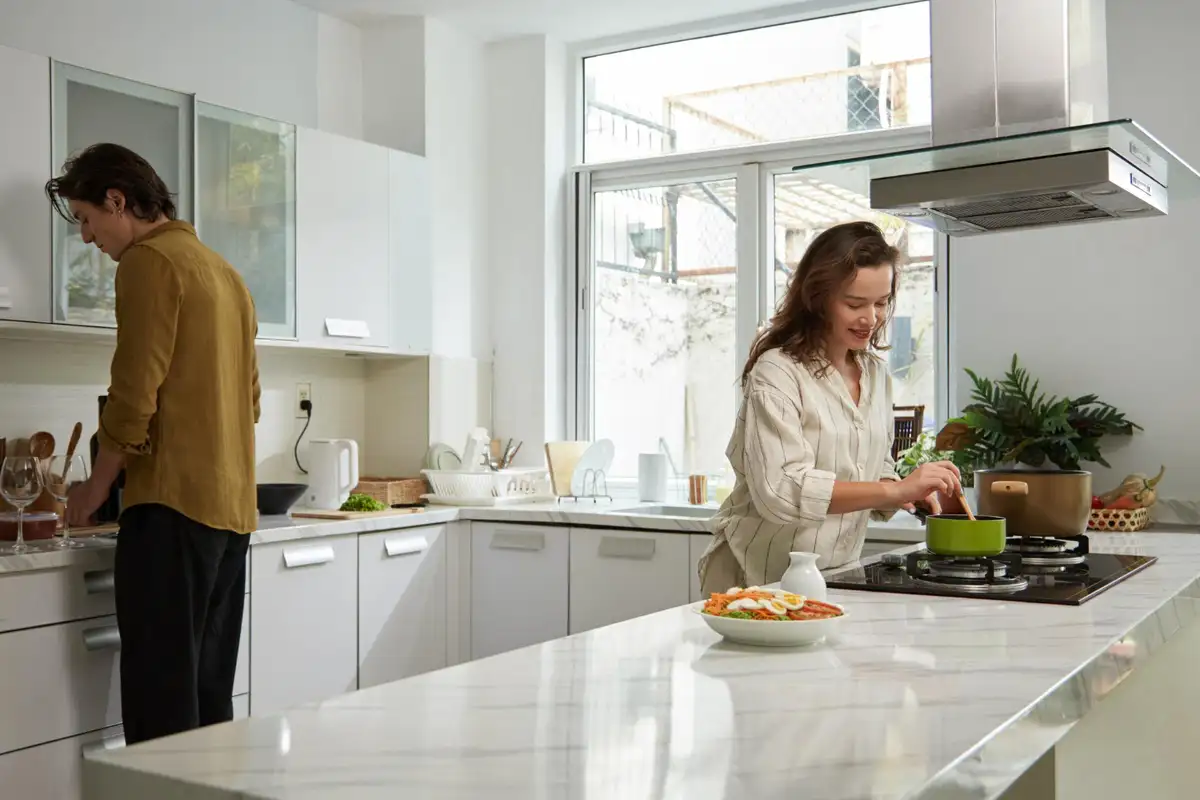 Couples prepares food on quarts vs granite countertops