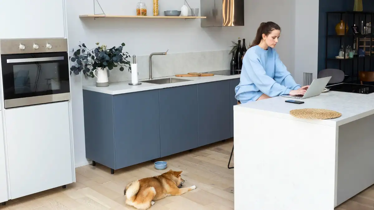 Women sits on a waterfall kitchen islands in a modern kitchen