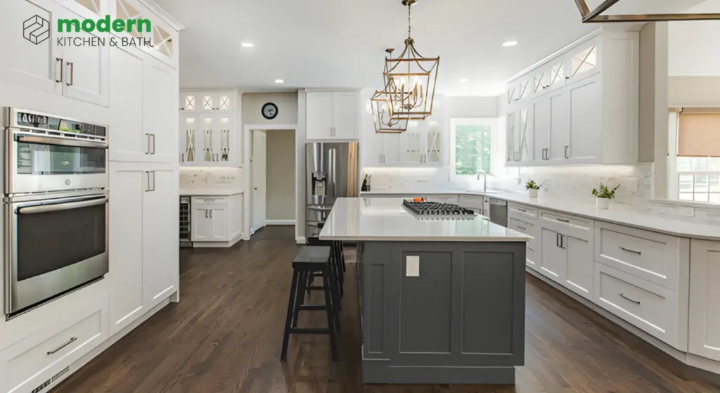 Mid-range kitchen remodel in Herndon VA featuring white shaker cabinets, gray island, quartz countertops, and hardwood flooring by Modern Kitchen & Bath