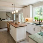 Sustainable kitchen remodel in Northern Virginia featuring white shaker cabinets, butcher block island, green quartz countertop, induction cooktop, and ENERGY STAR appliances by Modern Kitchen and Bath
