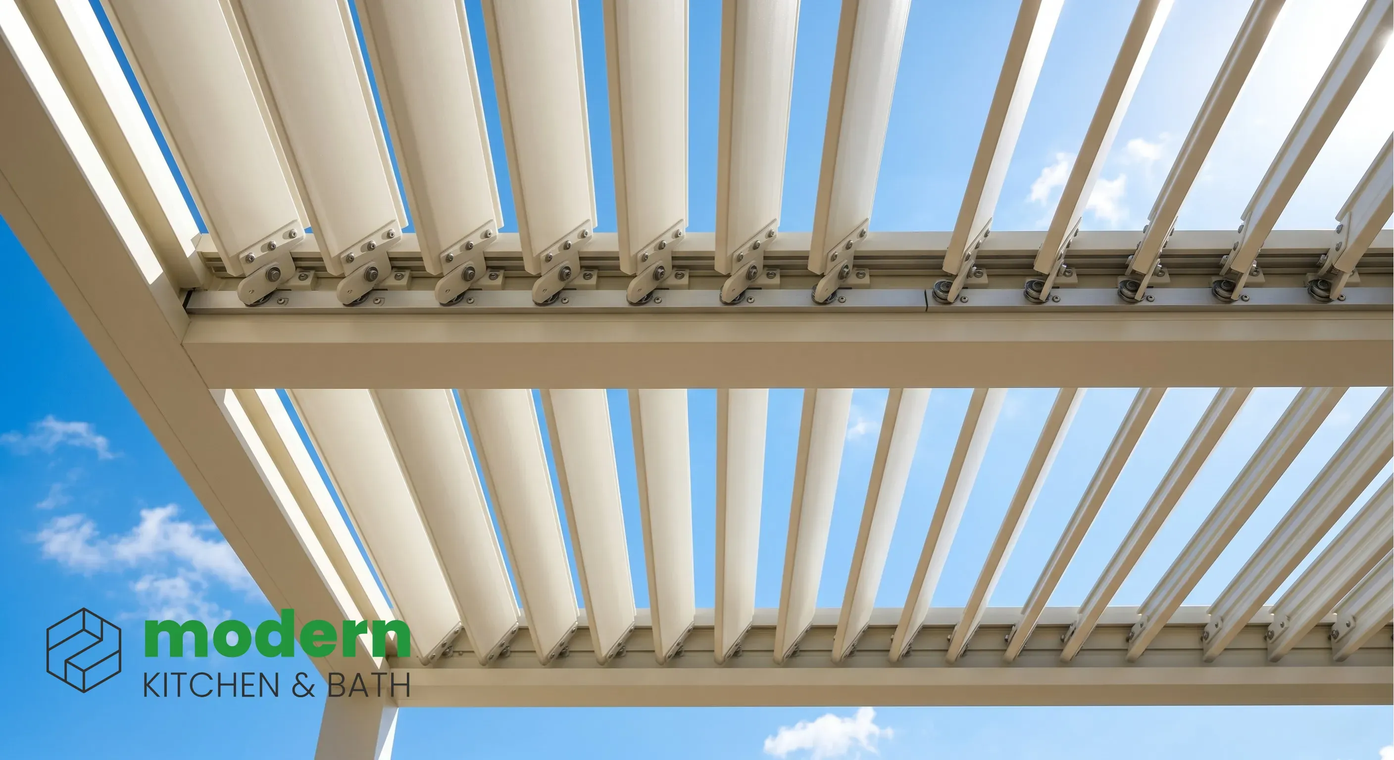Underside of an aluminum louvered pergola with blades tilted open against a blue sky